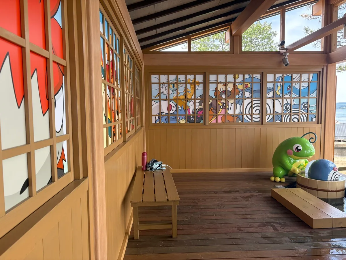 施設内部。ポケモンの障子アートとベンチ、キャタピーとポリワールのフィギュア